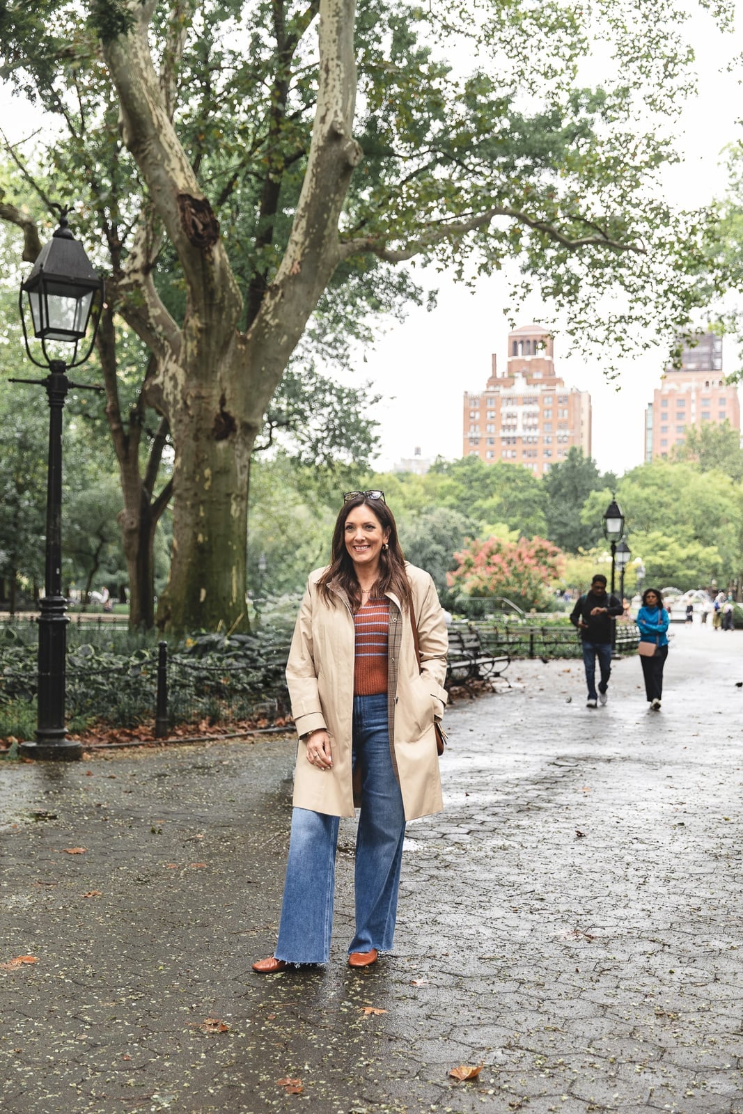 Beige Trench Coat with Striped Top and Wide-Leg Jeans — Rain Jacket Outfits