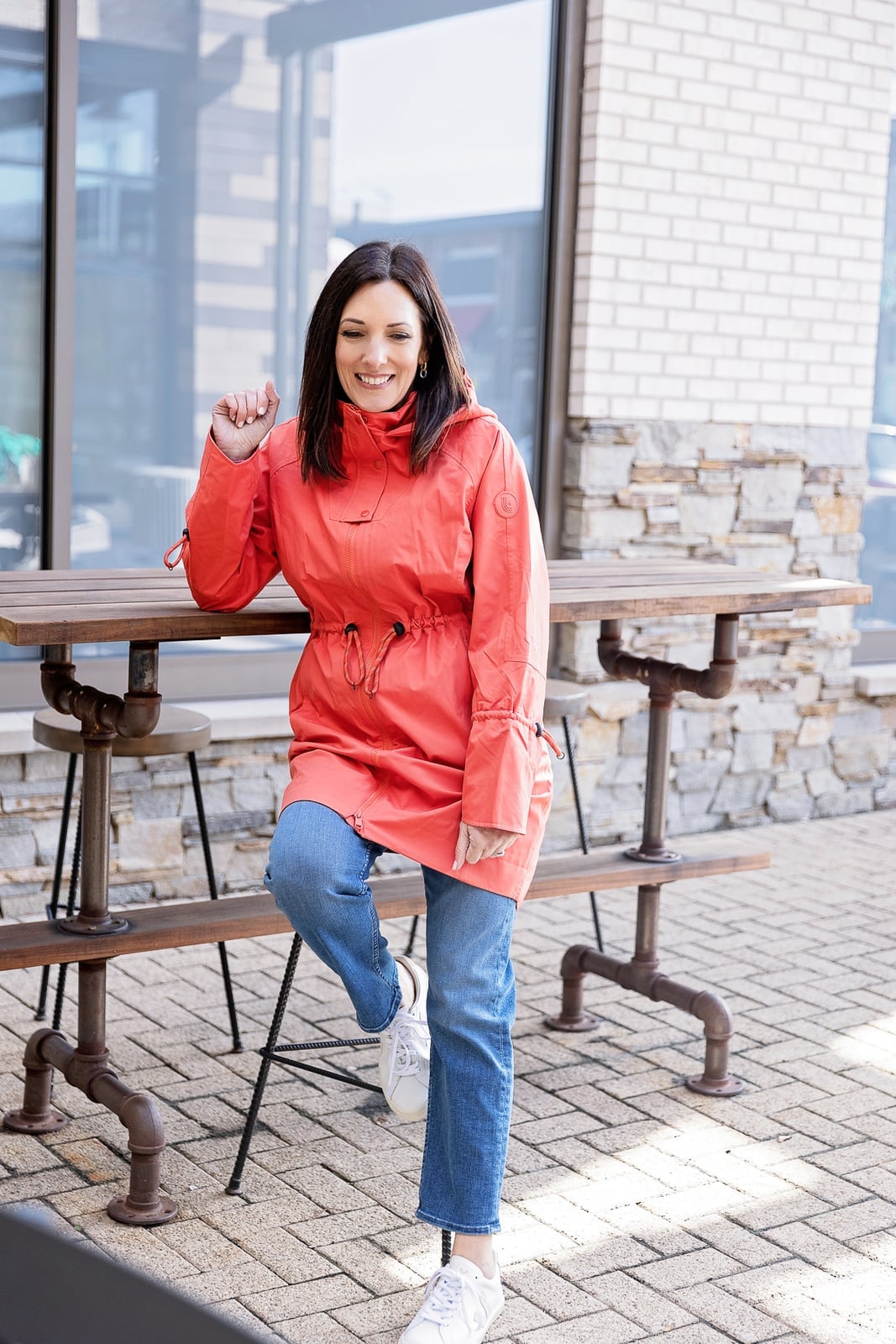 Coral Hooded Rain Jacket with Drawstring Waist and Blue Jeans — Rain Jacket Outfits