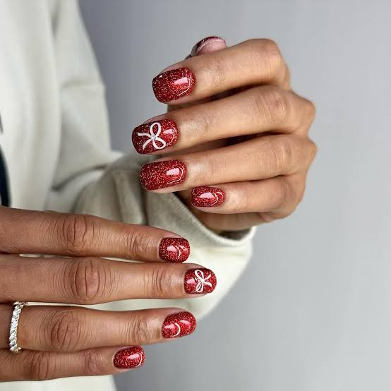 Short Square Glitter Red Nails with Bows, Close-Up Take Short Square Glitter Red Nails with Bows, Close-Up Take — Red Christmas Nails Designs