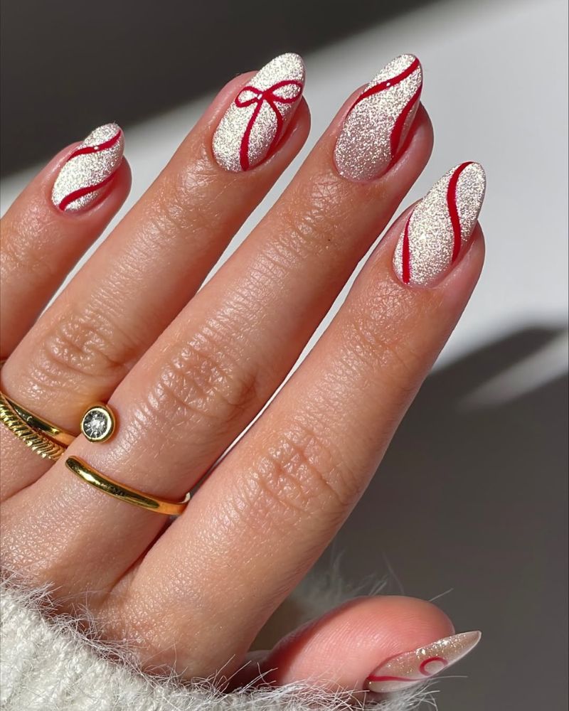 Medium Almond Silver Glitter Red Swirls Bow Medium Almond Silver Glitter Red Swirls Bow — Red Christmas Nails Designs