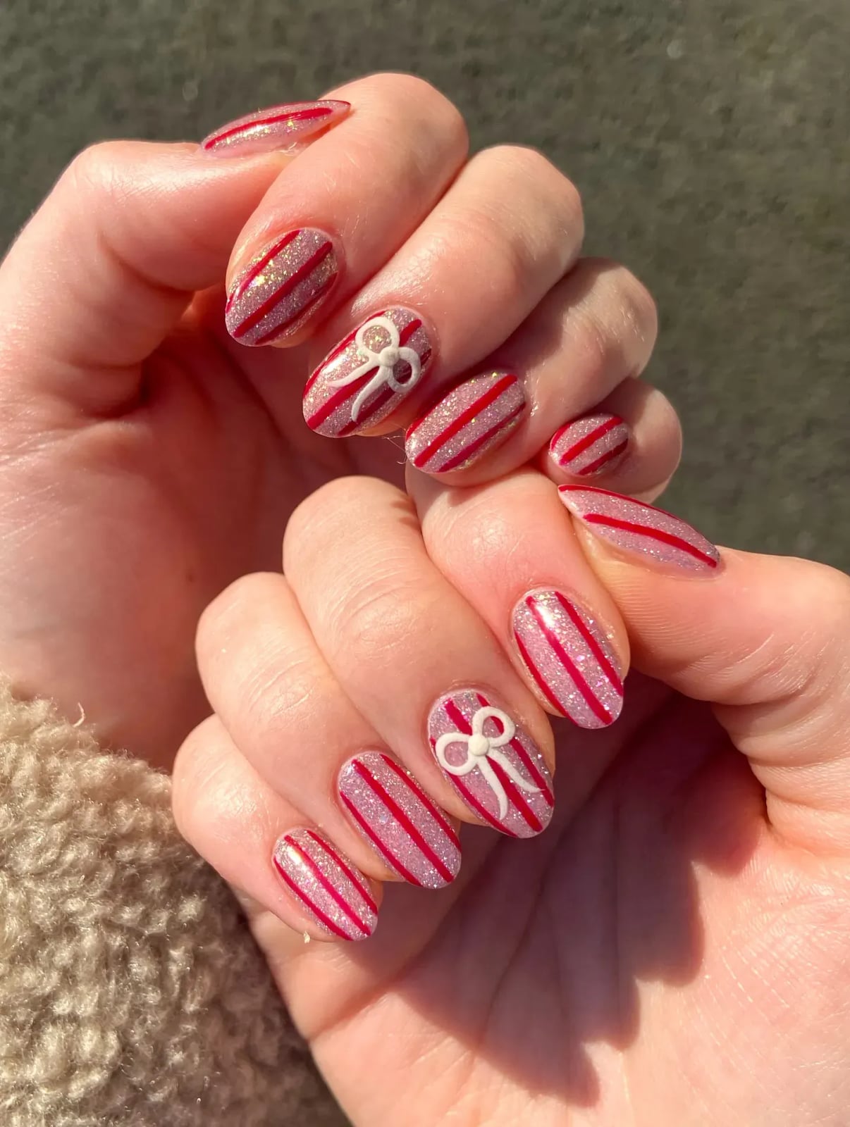 Medium Oval Red Stripe White Bow Nails, Close-Up Take Medium Oval Red Stripe White Bow Nails, Close-Up Take — Red Christmas Nails Designs