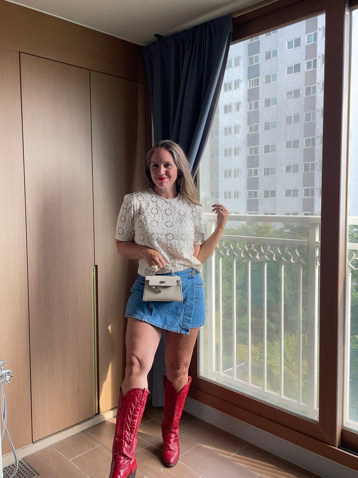 Red Cowboy Boots With Crochet Top and Denim Skirt and White Belt Bag — Red Cowboy Boots Outfit