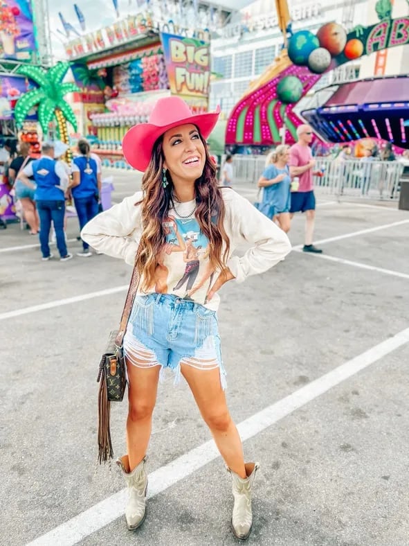 Distressed Denim Shorts With Graphic Sweatshirt and Pink Cowboy Hat Distressed Denim Shorts With Graphic Sweatshirt and Pink Cowboy Hat — Rodeo Outfits for Women