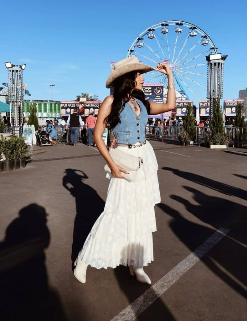 Denim Vest Over Tiered Lace Maxi Skirt With White Cowboy Boots Denim Vest Over Tiered Lace Maxi Skirt With White Cowboy Boots — Rodeo Outfits for Women