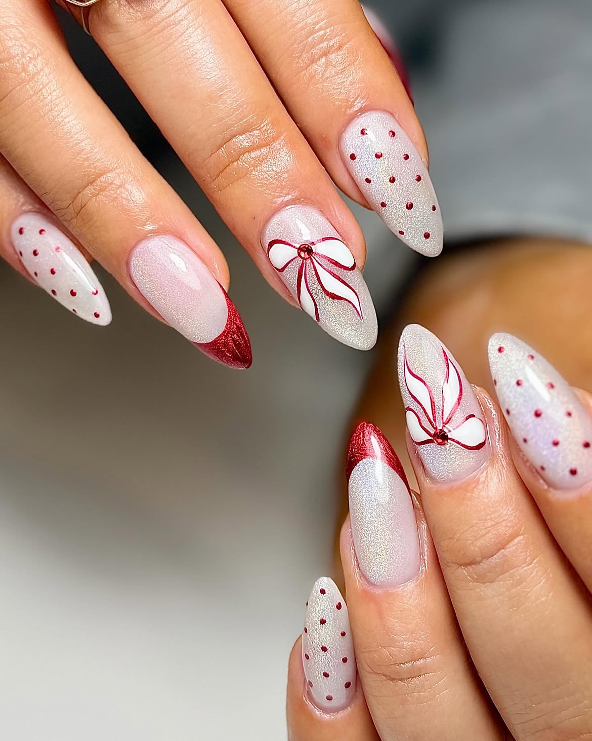 Shimmering White Cat Eye Nails With Red Bows