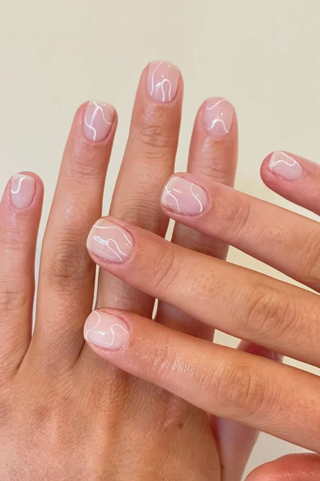 Sheer Nude with Thin White Curved Lines Sheer Nude with Thin White Curved Lines — Short Round Nails