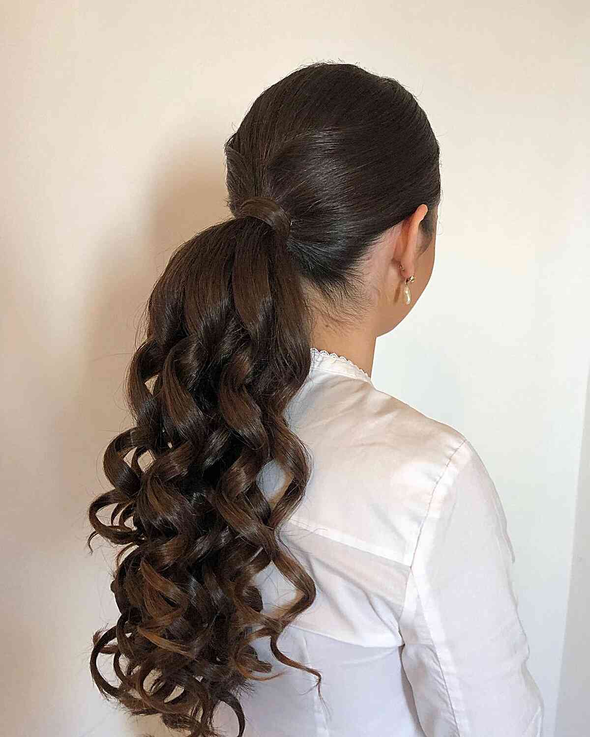 Glossy Dark Brown Mid-Back Ponytail With The Curls Cascading Down — Side Part Ponytail