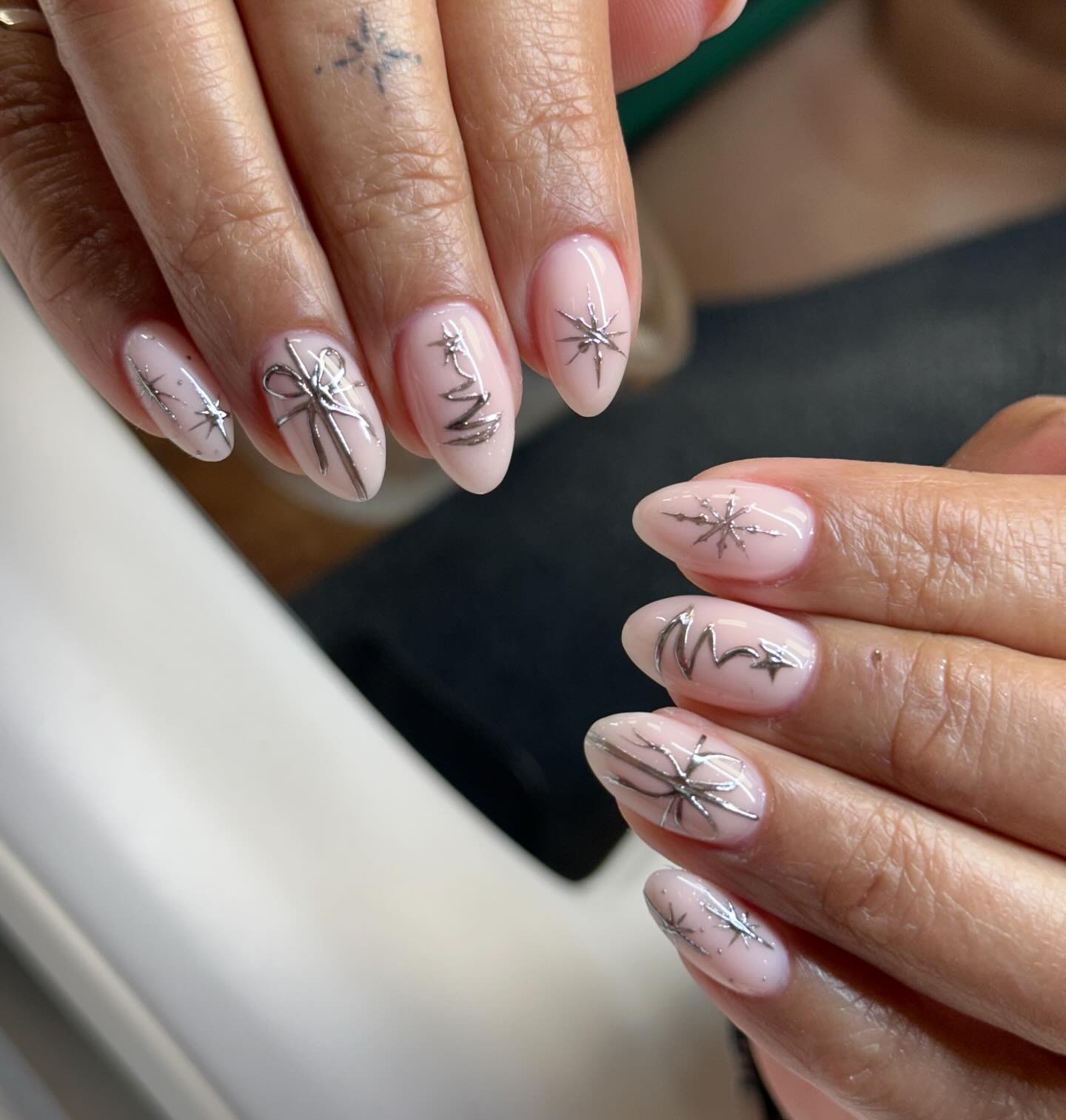 Silver Christmas Art on Milky Pink Oval Nails