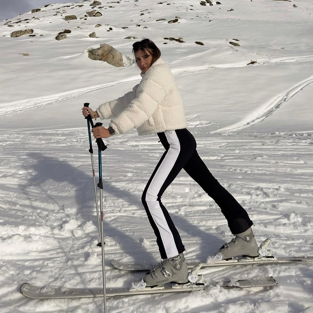 Cropped cream fluffy jacket over black ski pants — Skiing Outfit