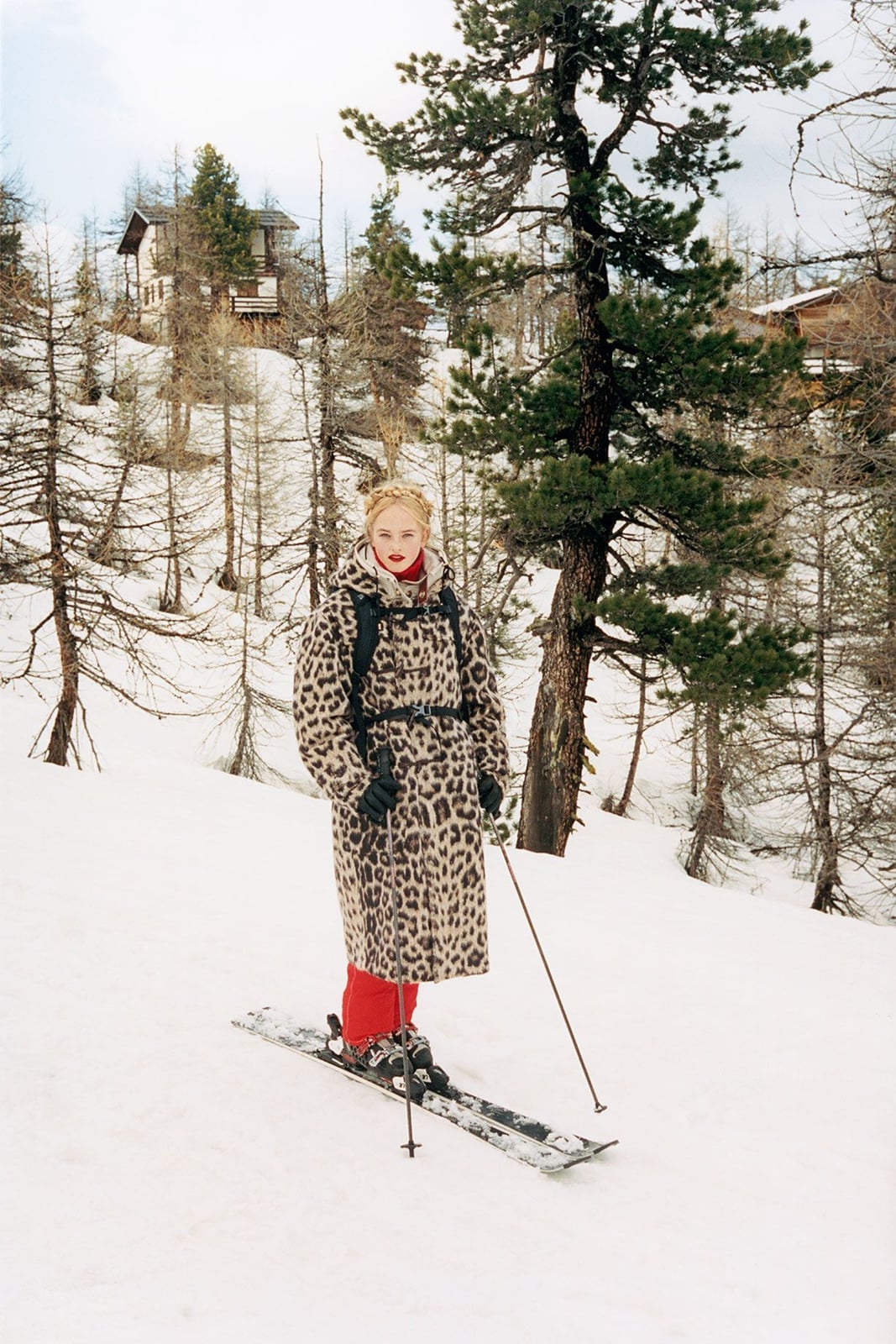 Long leopard print coat over red base layer — Skiing Outfit