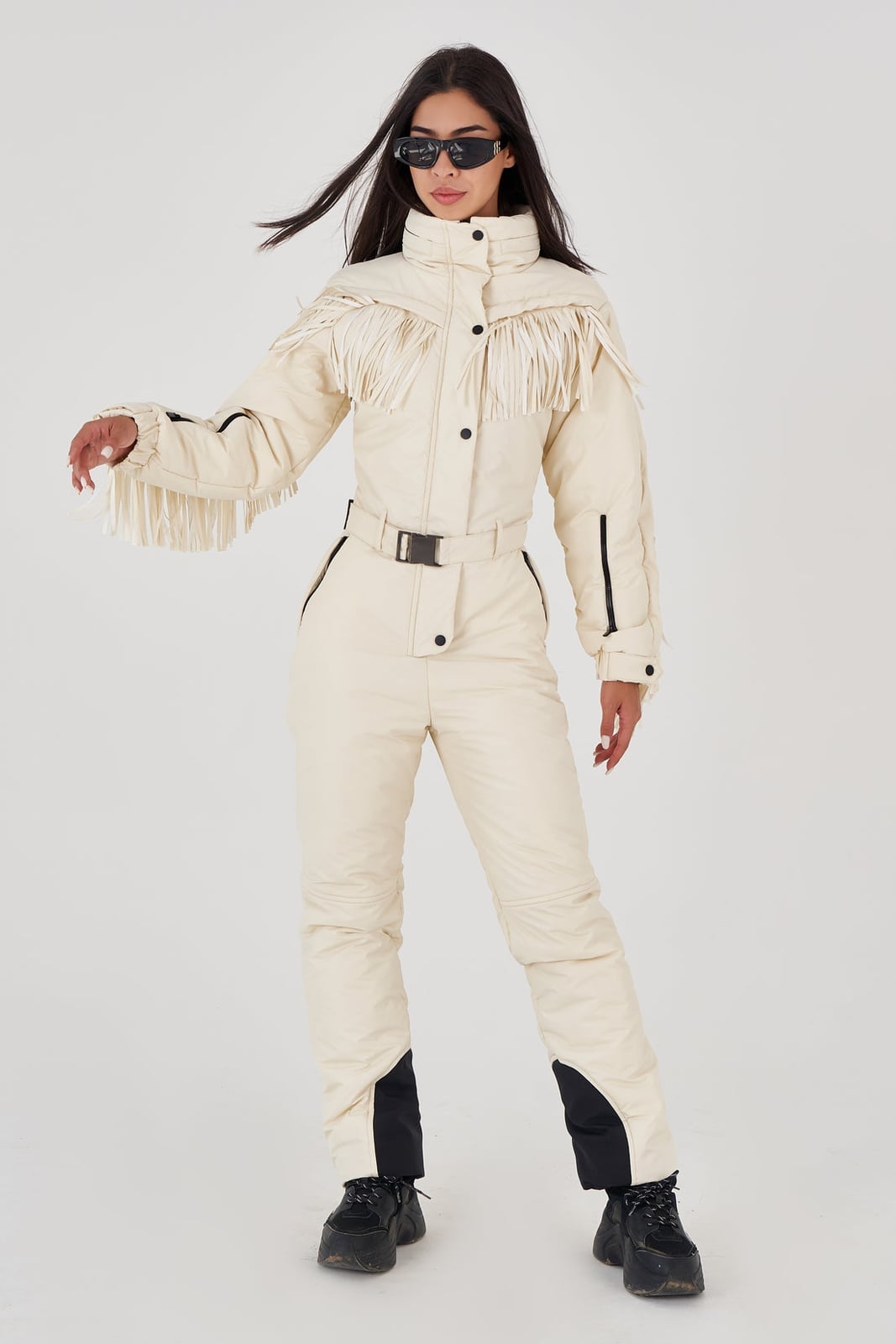 Cream ski suit with fringe detailing and black belt — Skiing Outfit