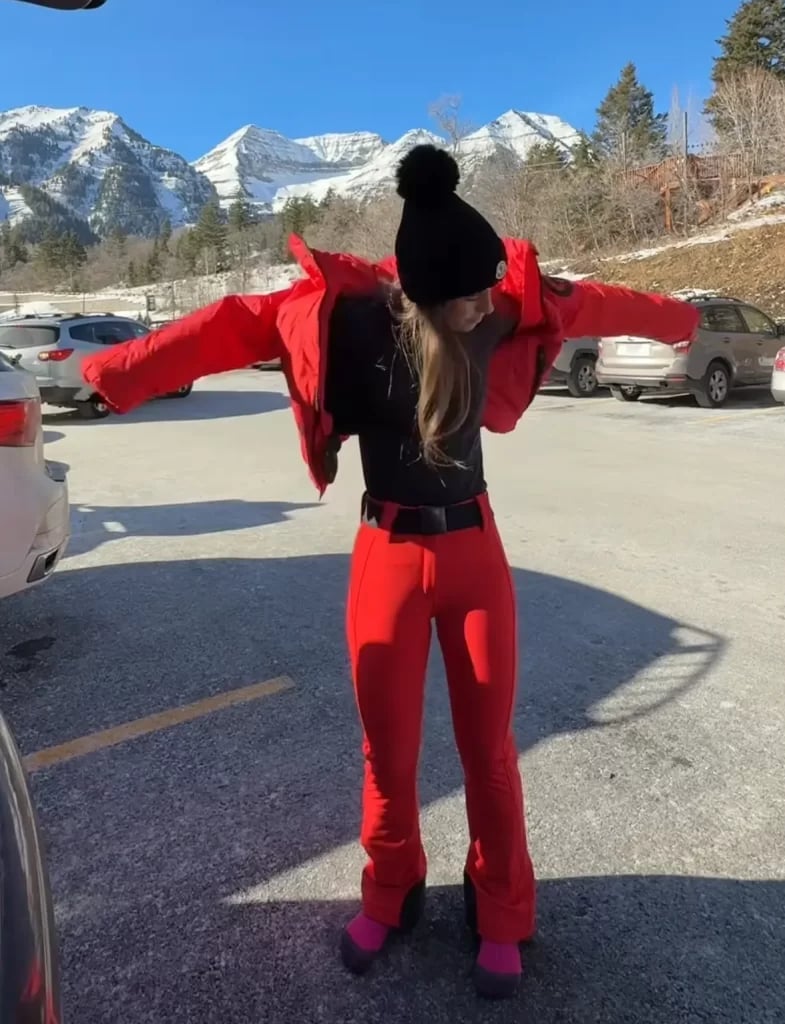 Bright red ski suit with black top and pink boots — Skiing Outfit