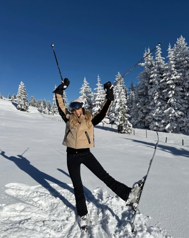 Beige puffer vest over black top and ski pants — Skiing Outfit