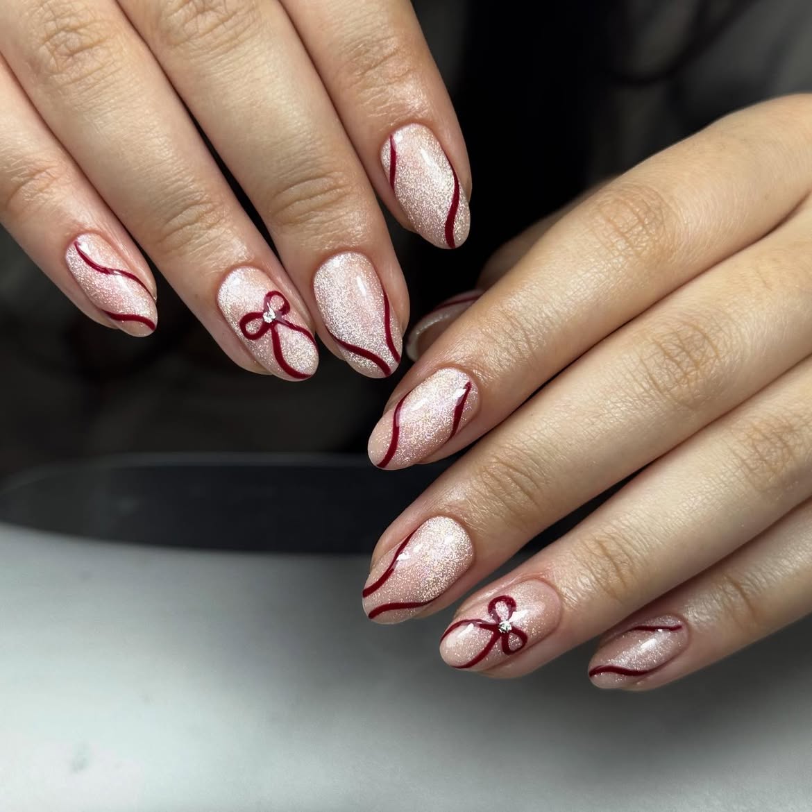 Sparkling Cranberry Bow Almond Nails