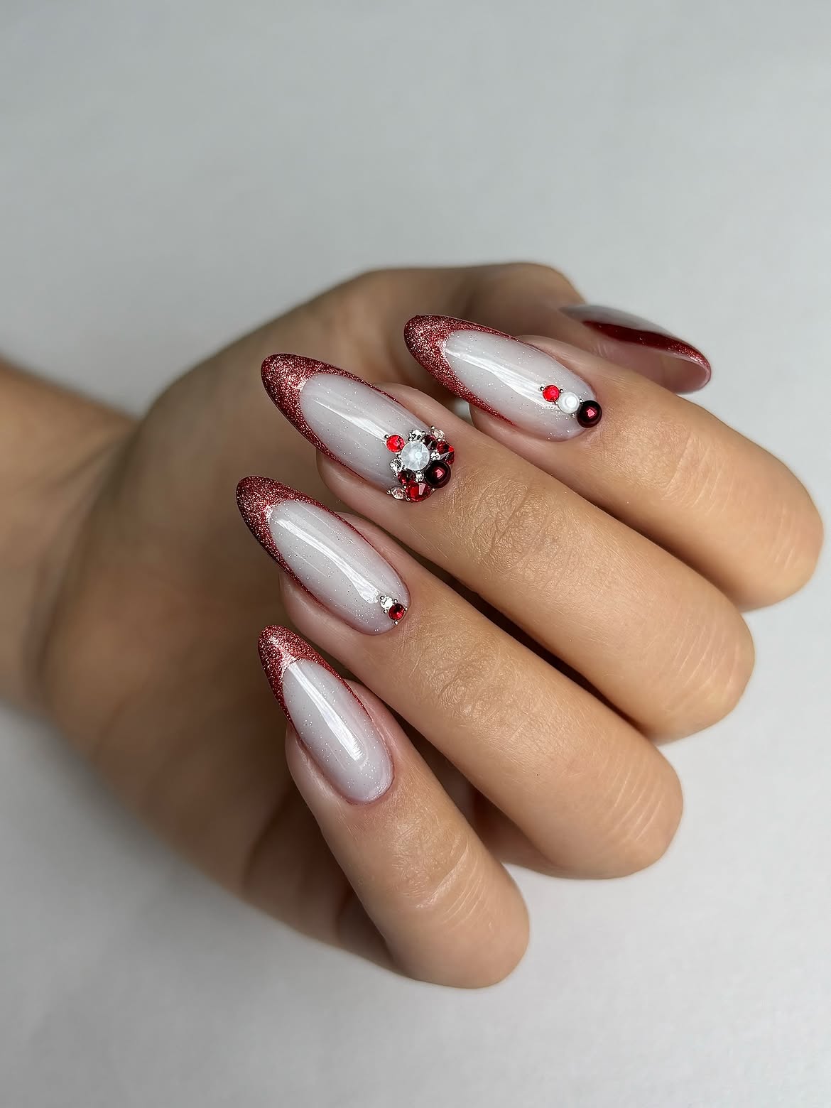 Sparkling Red French Tip Almond Nails with Jewels