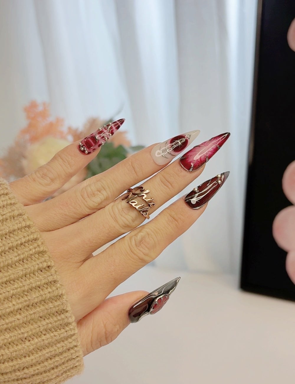 Dark Red Chrome Stiletto Nails with Silver Accents