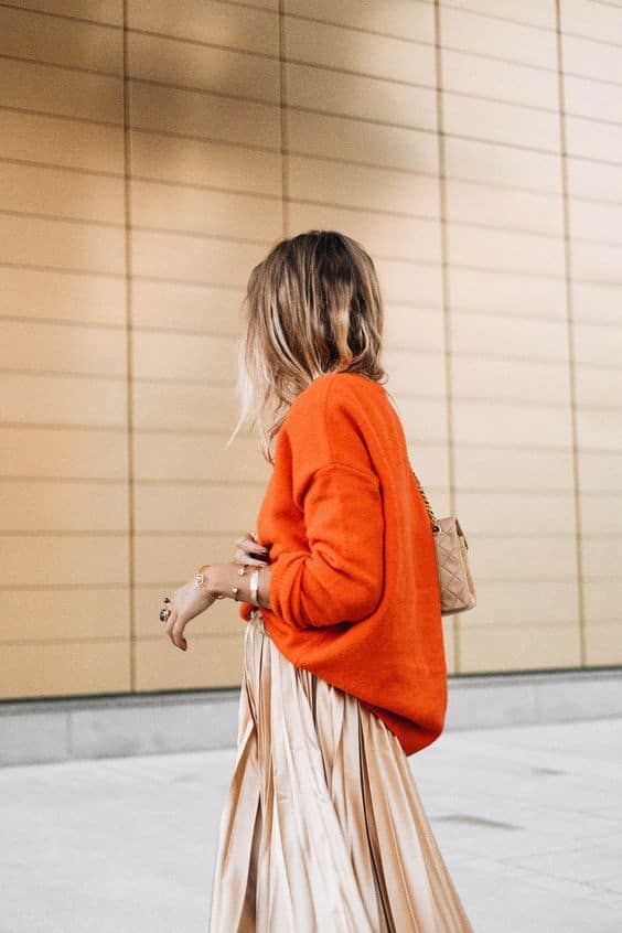 Vibrant Orange Crewneck Sweater with Satin Midi Skirt, Close-Up Take — Sweater Outfits for Women