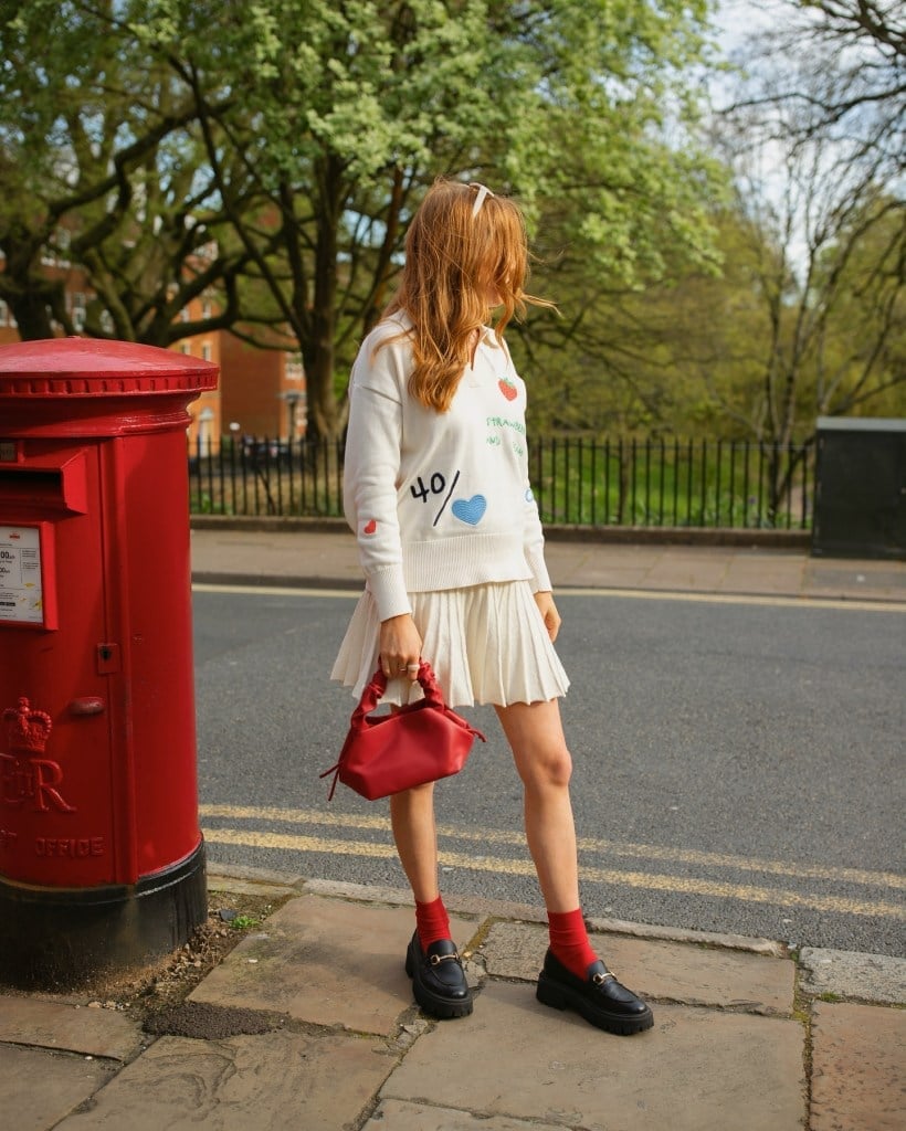 White Pleated Mini Skirt with Graphic Sweater and Loafers White Pleated Mini Skirt with Graphic Sweater and Loafers — Tennis Skirt Outfits