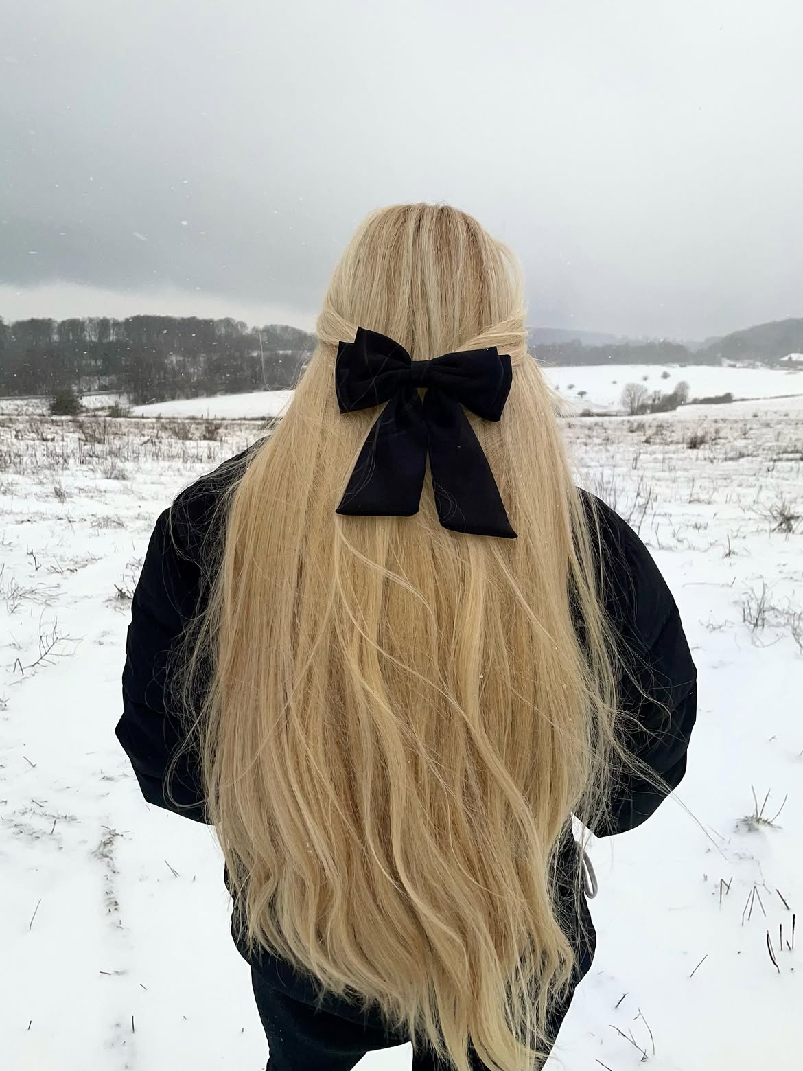 Voluminous Blonde Waves with Black Velvet Bow