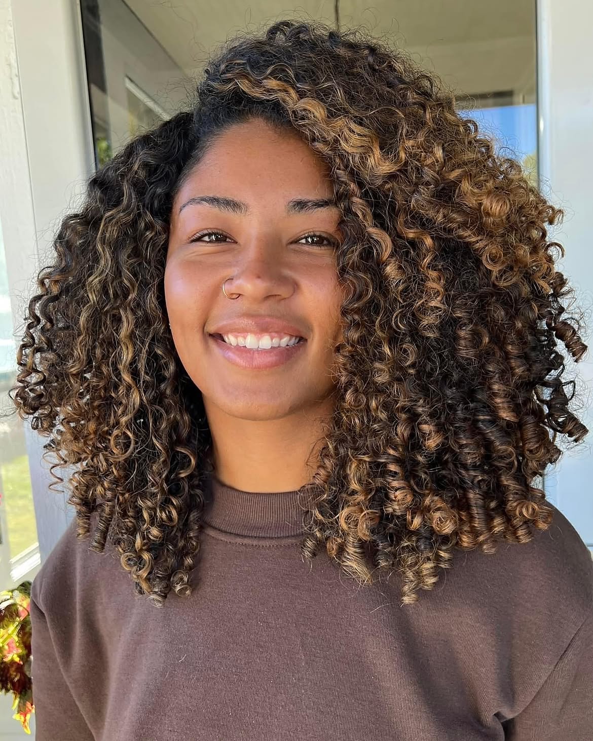 Warm Honey Blonde Highlights On Voluminous Curls