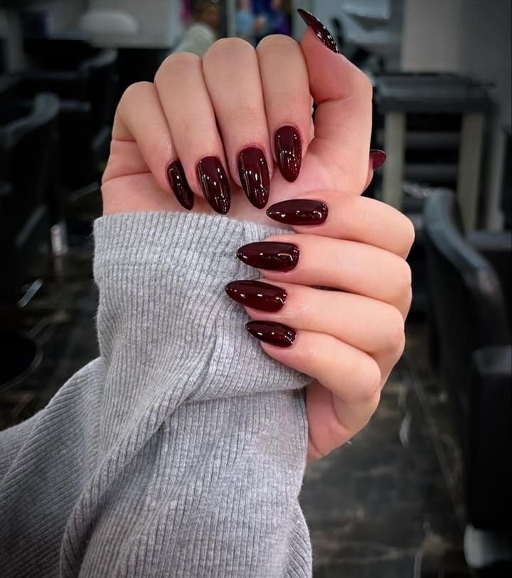 Deep Maroon Glossy Medium Almond Nails, Close-Up Take Deep Maroon Glossy Medium Almond Nails, Close-Up Take — Wine Nails