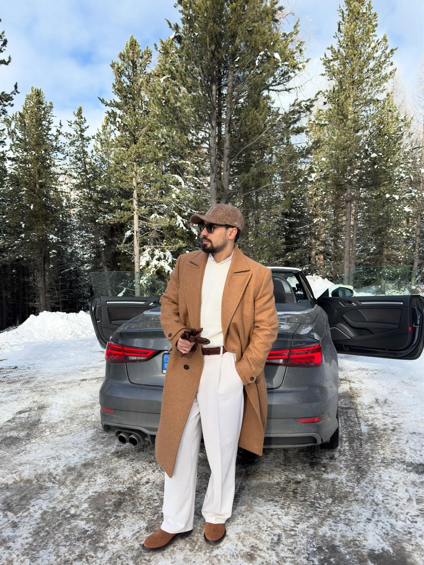 Winter Chic: Camel Coat Over Cream Knit and White Trousers
