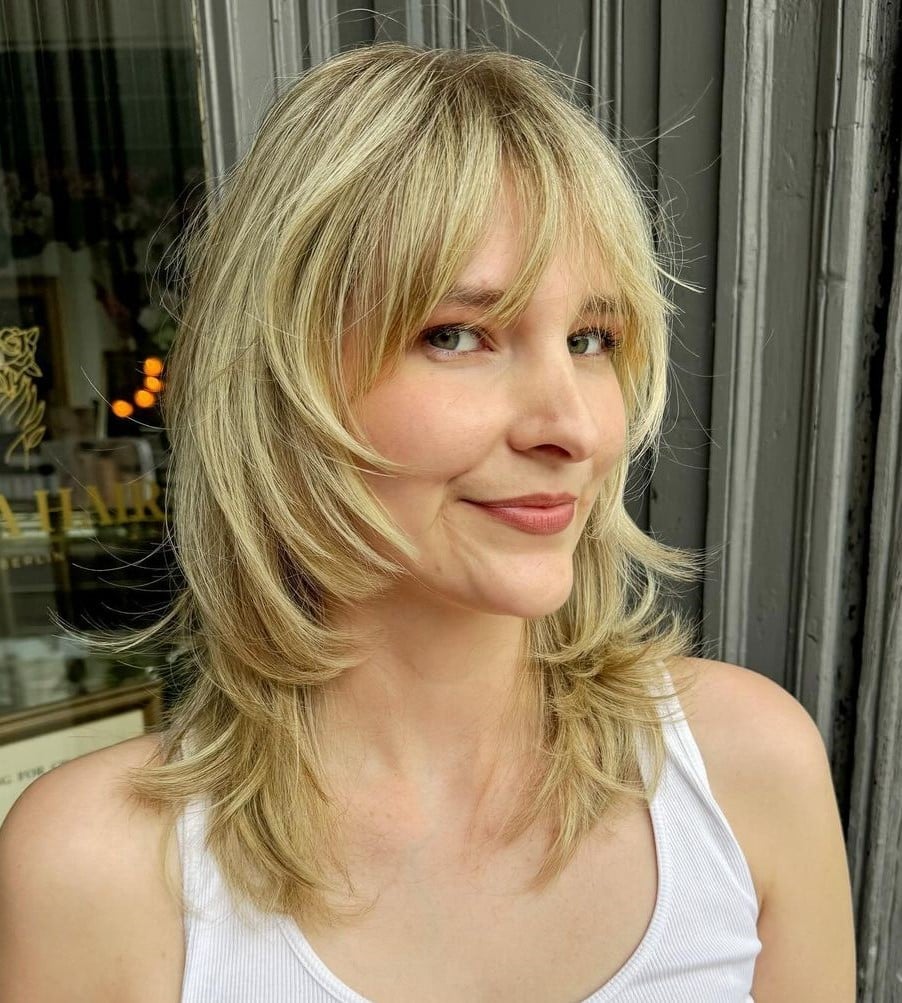 Blonde Collarbone Wolf Cut With Curtain Bangs, Close-Up Take Blonde Collarbone Wolf Cut With Curtain Bangs, Close-Up Take