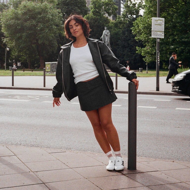 Black Bomber Jacket Over White T-Shirt with Gray Mini Skirt Black Bomber Jacket Over White T-Shirt with Gray Mini Skirt — Y2K Party Outfit