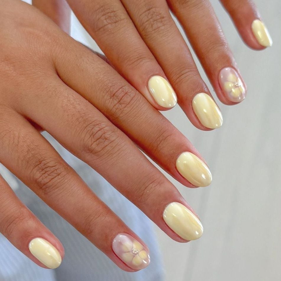Short Oval Pale Milky Yellow With Flower Accents — Yellow Nails